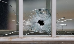 A bullet's impact is seen on a window at the scene after a shooting at the Paris offices of Charlie Hebdo, a satirical newspaper, January 7, 2015. Eleven people were killed and 10 injured in shooting at the Paris offices of the satirical weekly Charlie Hebdo, already the target of a firebombing in 2011 after publishing cartoons deriding Prophet Mohammad on its cover, police spokesman said. Five of the injured were in a critical condition, said the spokesman. Separately, the government said it was raising France's national security level to the highest notch.    REUTERS/Jacky Naegelen (FRANCE - Tags: CRIME LAW MEDIA) - RTR4KDIY